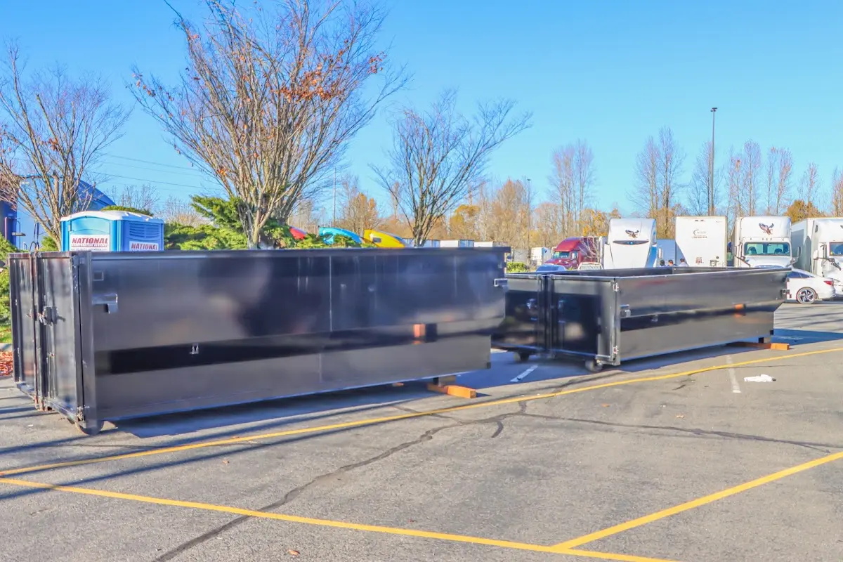 Professional dumpster rental service with roll-off container on residential driveway in Darby